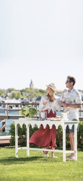 CONSOLE, TABLETOP GLASSWARE, JEWELRY: Centre Pointe 
ON HER — TOP, SHOES: Milly & Grace, SKIRT: Commonwealth
HAT: Perch 
ON HIM — SHIRT, SHORTS: Faherty, SUNGLASSES: ACK Eye, SHOES: Vineyard Vines 